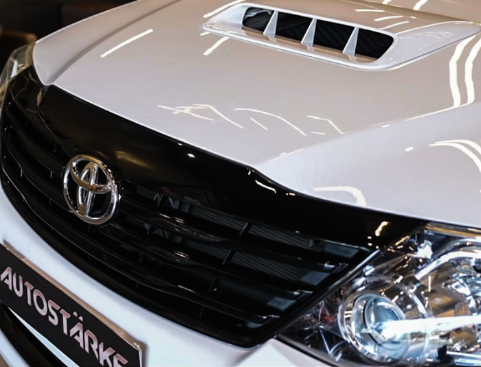 Toyota Fortuner with JDM white exterior painting and caliper finish by Autostarke in Kerala